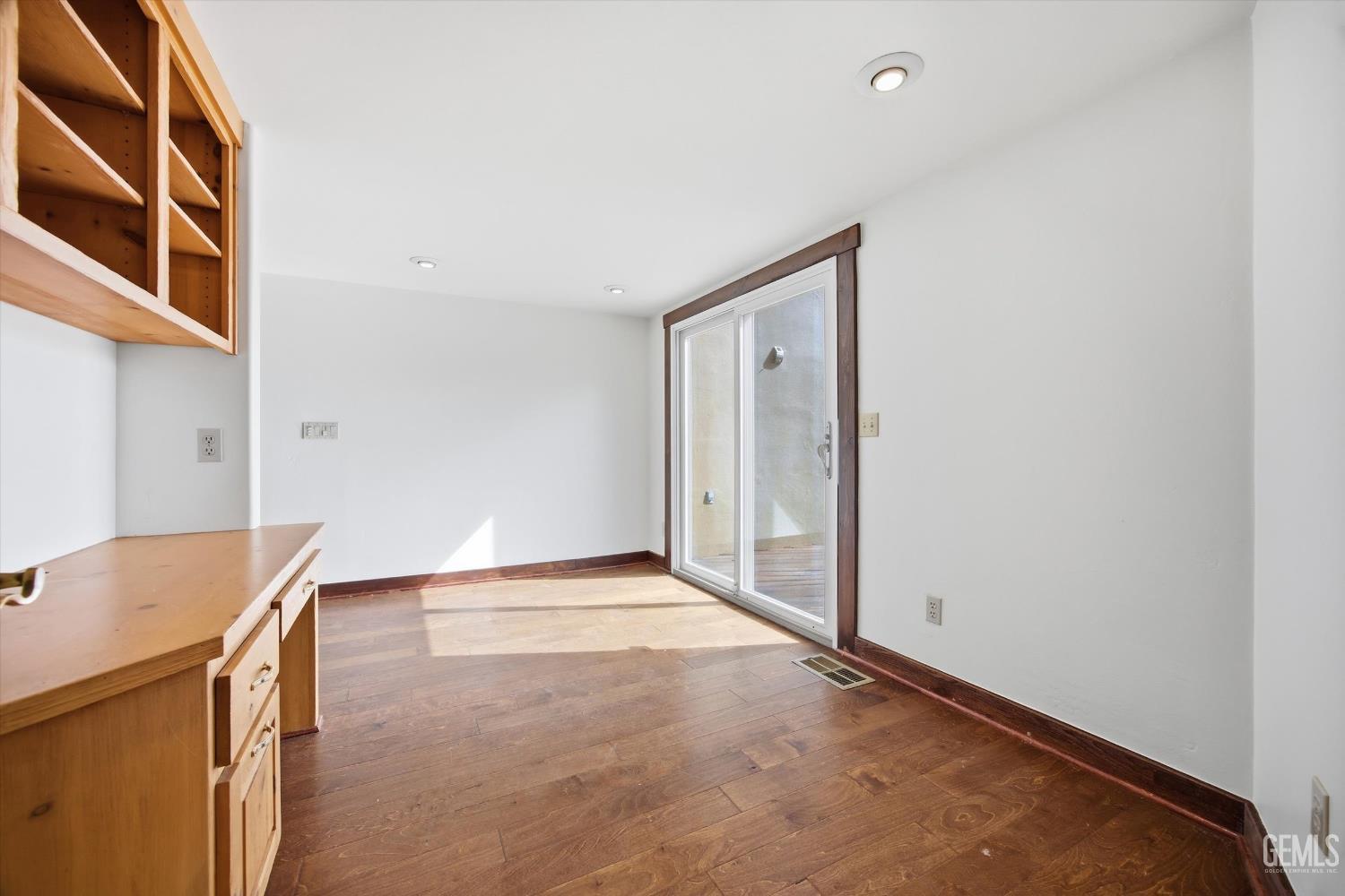 Undisclosed Address Tehachapi, CA 93561 - Photo 27 of 70 a view of an empty room with wooden floor and a cabinet