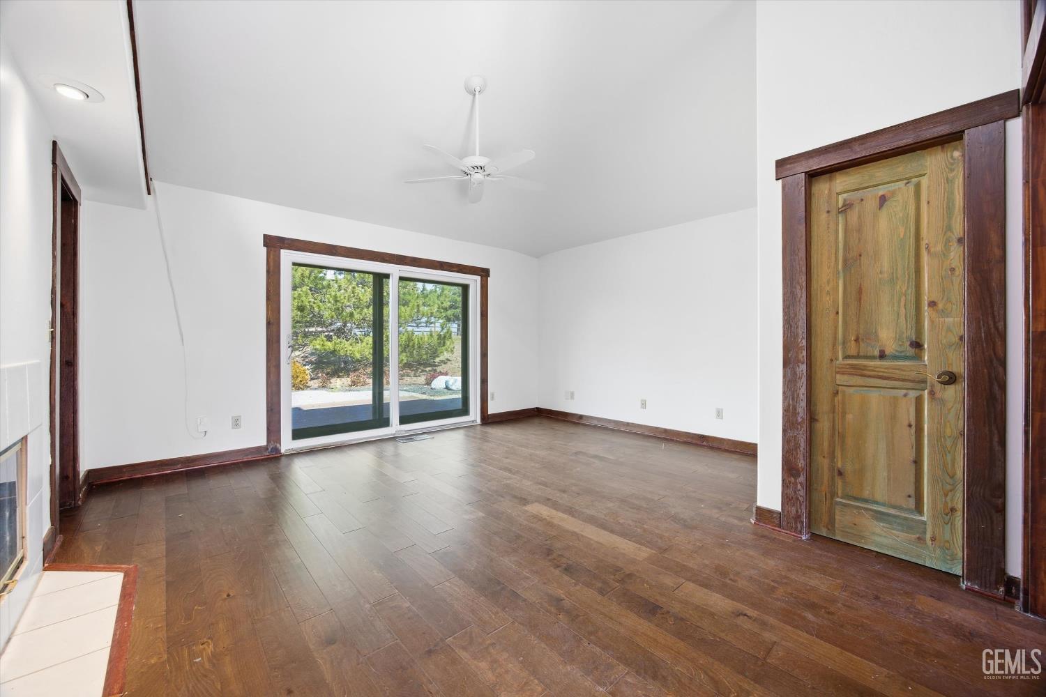Undisclosed Address Tehachapi, CA 93561 - Photo 29 of 70 an empty room with wooden floor and windows