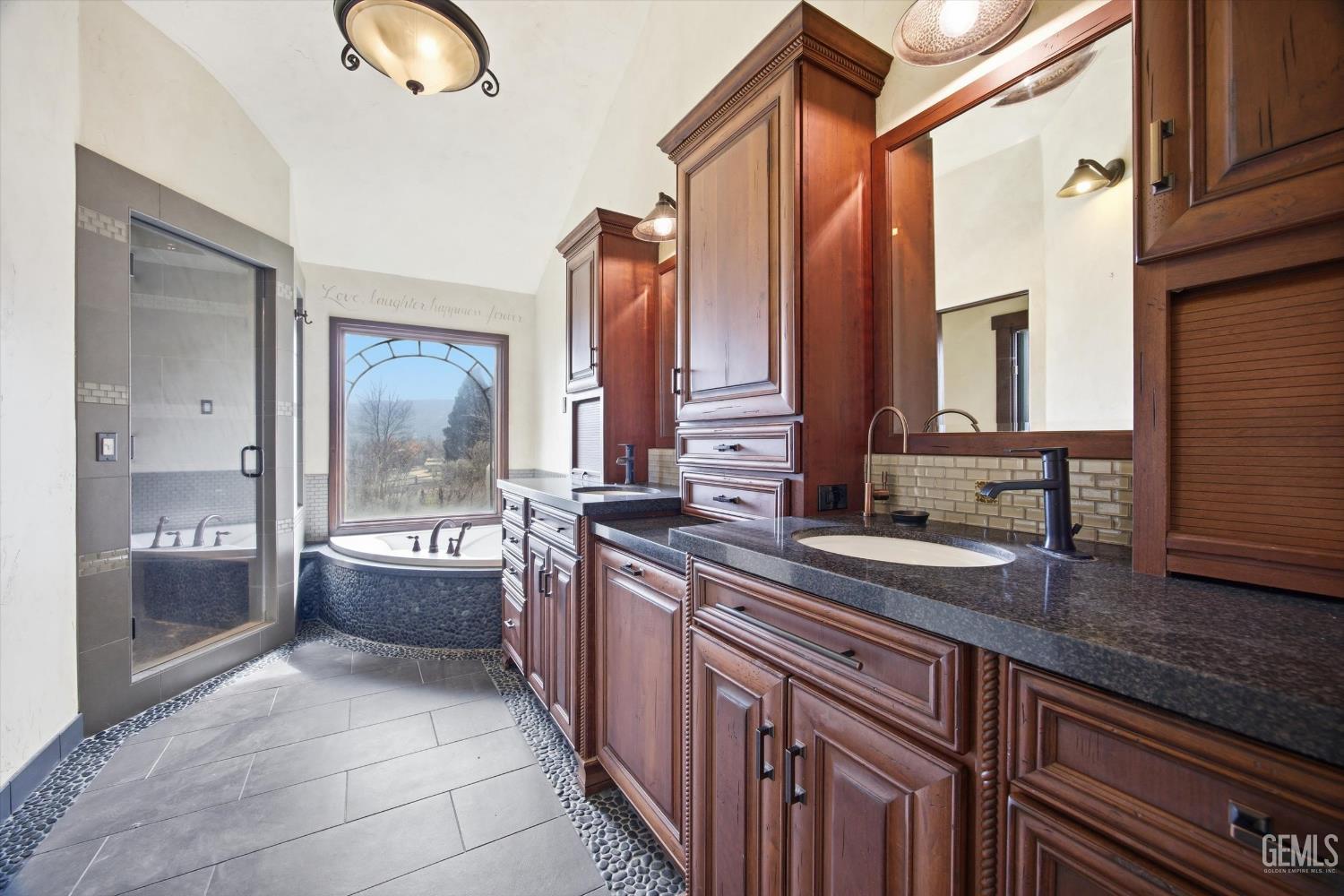 Undisclosed Address Tehachapi, CA 93561 - Photo 31 of 70 a large bathroom with a granite countertop double vanity sink a mirror and a bathtub