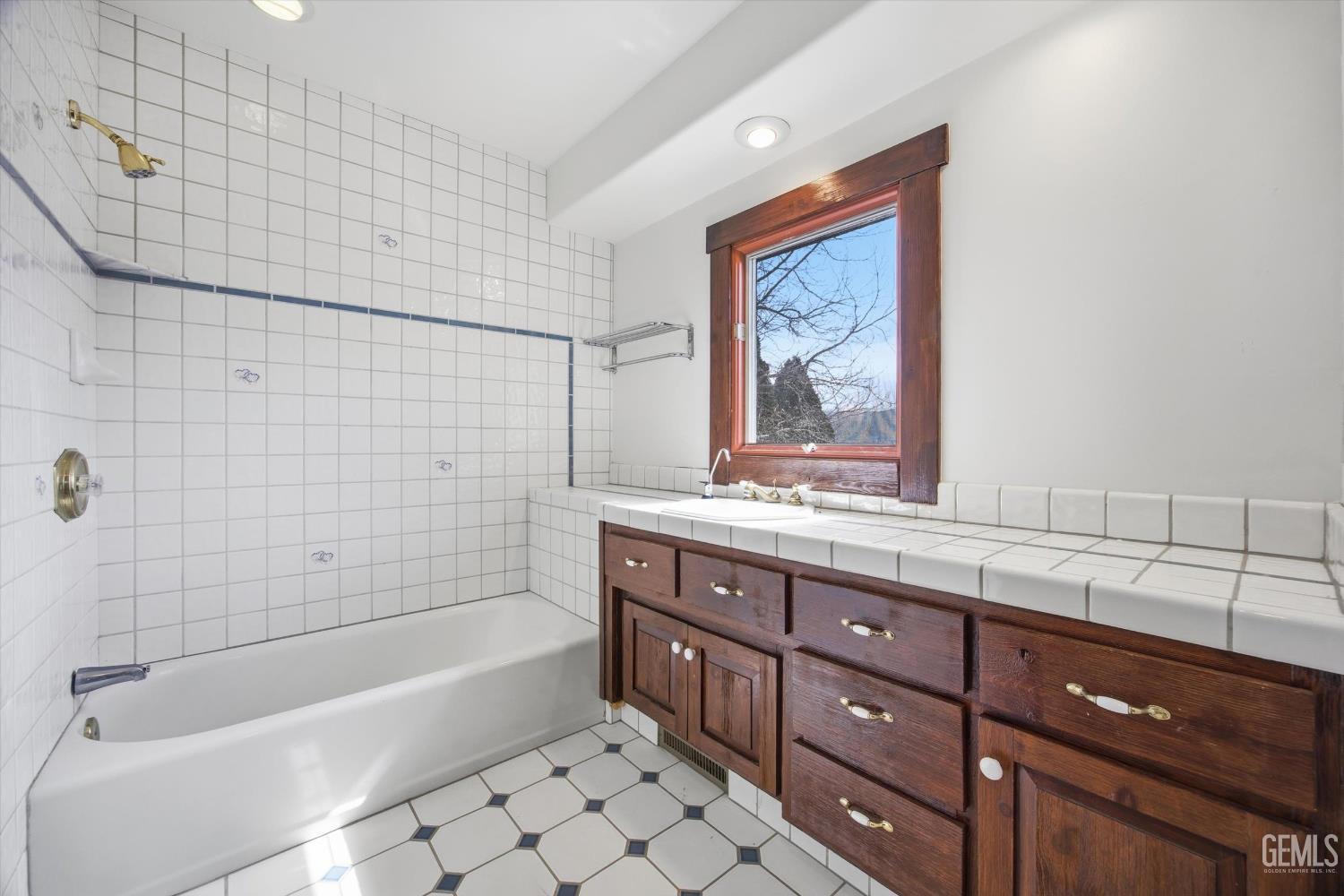 Undisclosed Address Tehachapi, CA 93561 - Photo 44 of 70 a bathroom with a granite countertop bathtub sink vanity and mirror