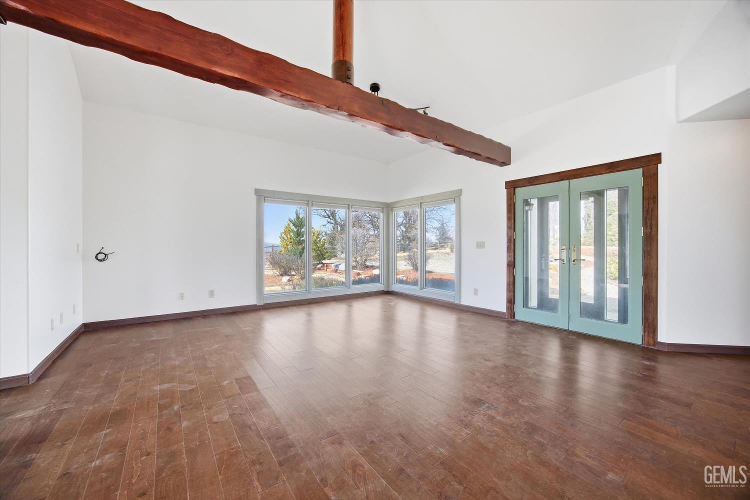Undisclosed Address Tehachapi, CA 93561 - Photo 46 of 70 a view of an empty room with wooden floor and a window