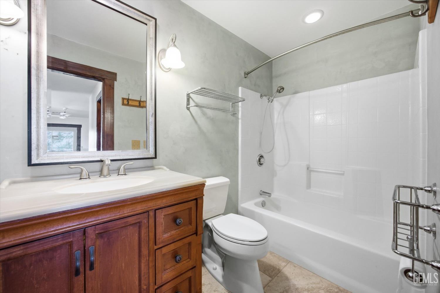 Undisclosed Address Tehachapi, CA 93561 - Photo 53 of 70 a bathroom with a sink a toilet a mirror a bathtub and shower