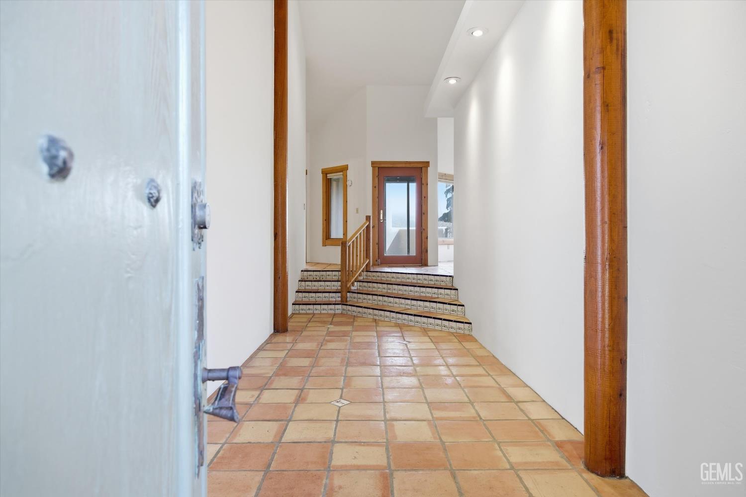 Undisclosed Address Tehachapi, CA 93561 - Photo 10 of 70 a view of a hallway with wooden floor and a bathroom