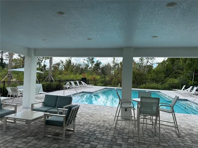 a view of a patio with a table chairs and backyard