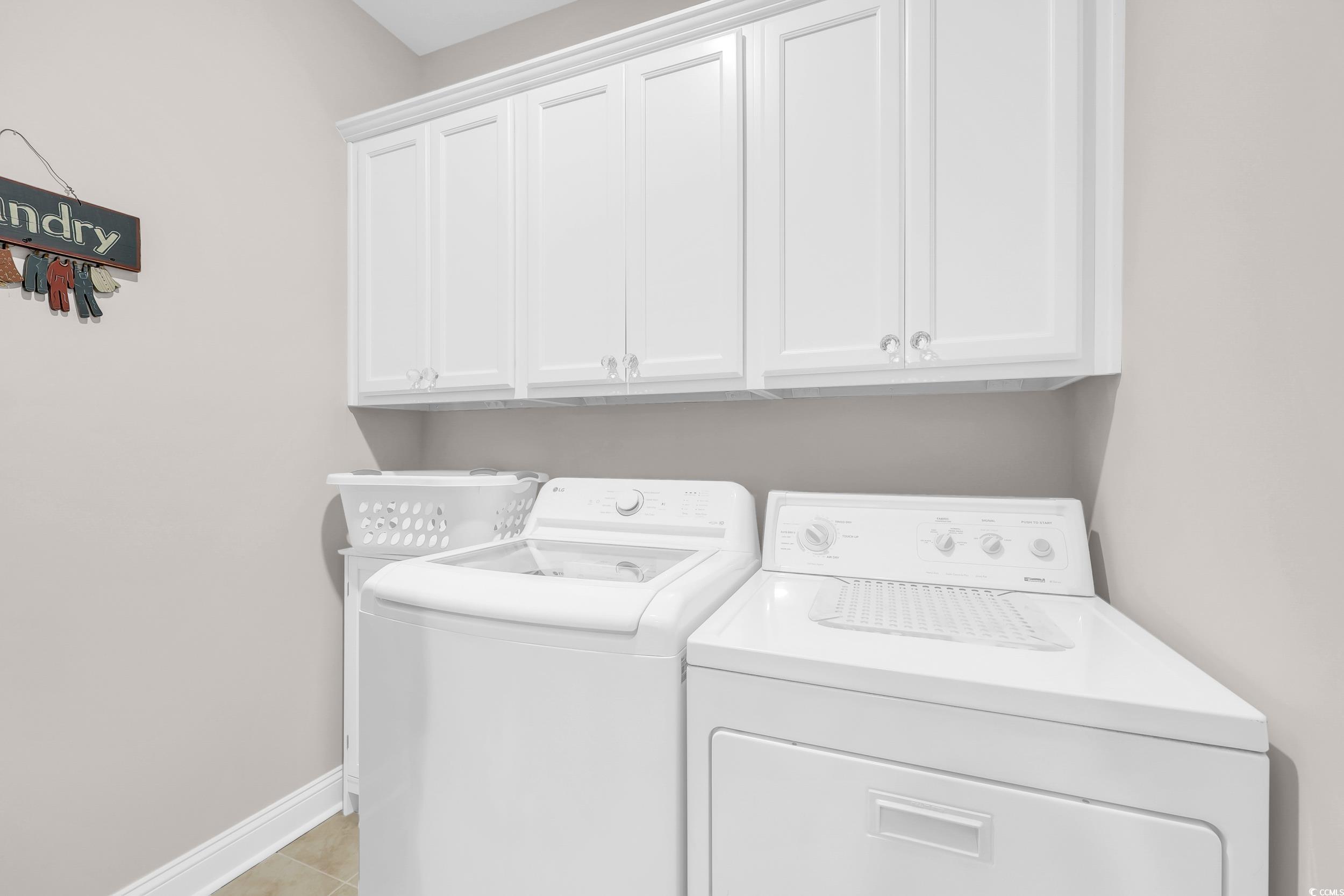 147 Machrie Loop, Unit D Myrtle Beach, SC 29588 - Photo 22 of 36 Laundry area featuring cabinet space, independent washer and dryer, and light tile patterned floors