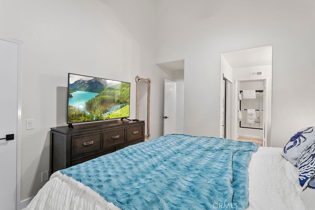 8 Coral Ridge, Unit 109 Laguna Niguel, CA 92677 - Photo 12 of 29 a bedroom with a bed and a flat screen tv