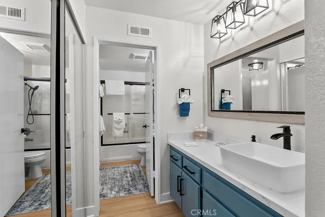 a bathroom with a shower sink and mirror