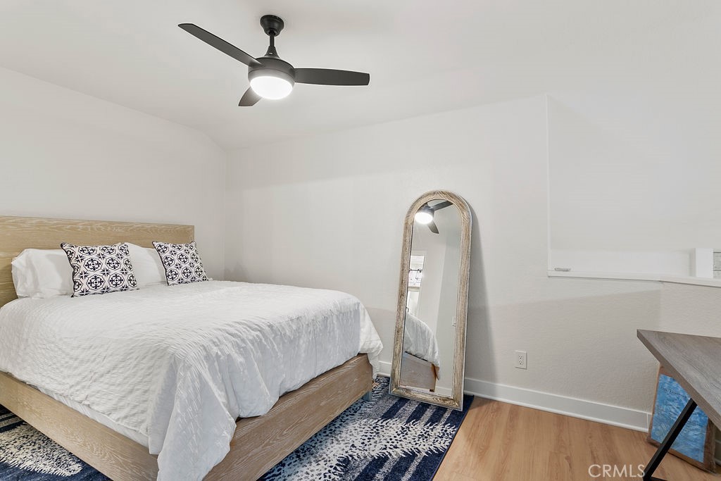 8 Coral Ridge, Unit 109 Laguna Niguel, CA 92677 - Photo 15 of 29 a bedroom with a bed and a chandelier