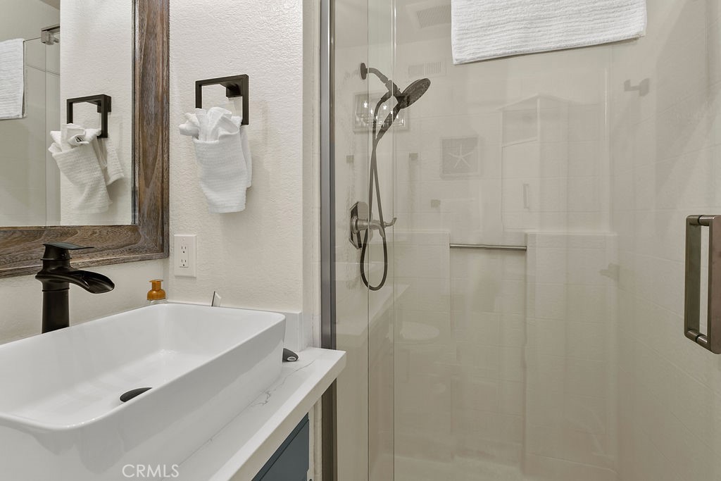 8 Coral Ridge, Unit 109 Laguna Niguel, CA 92677 - Photo 18 of 29 a bathroom with a sink vanity and shower