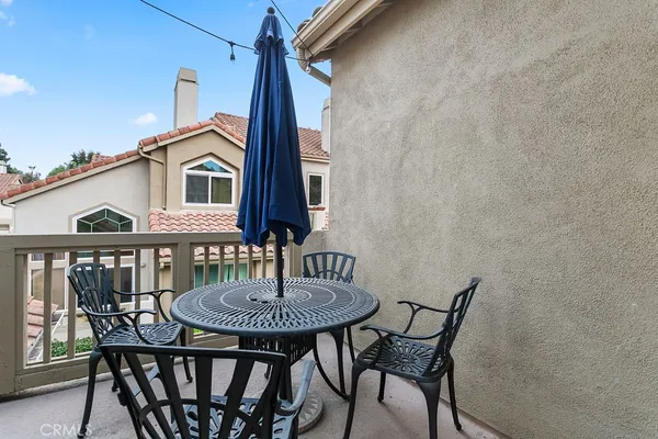 a view of a house with a table and chairs