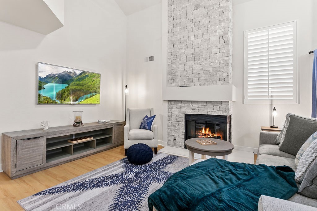 8 Coral Ridge, Unit 109 Laguna Niguel, CA 92677 - Photo 4 of 29 a living room with furniture and a fireplace