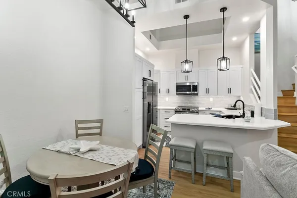 a kitchen with a sink a stove and chairs