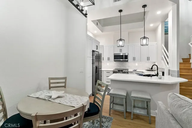 a kitchen with a sink a stove and chairs