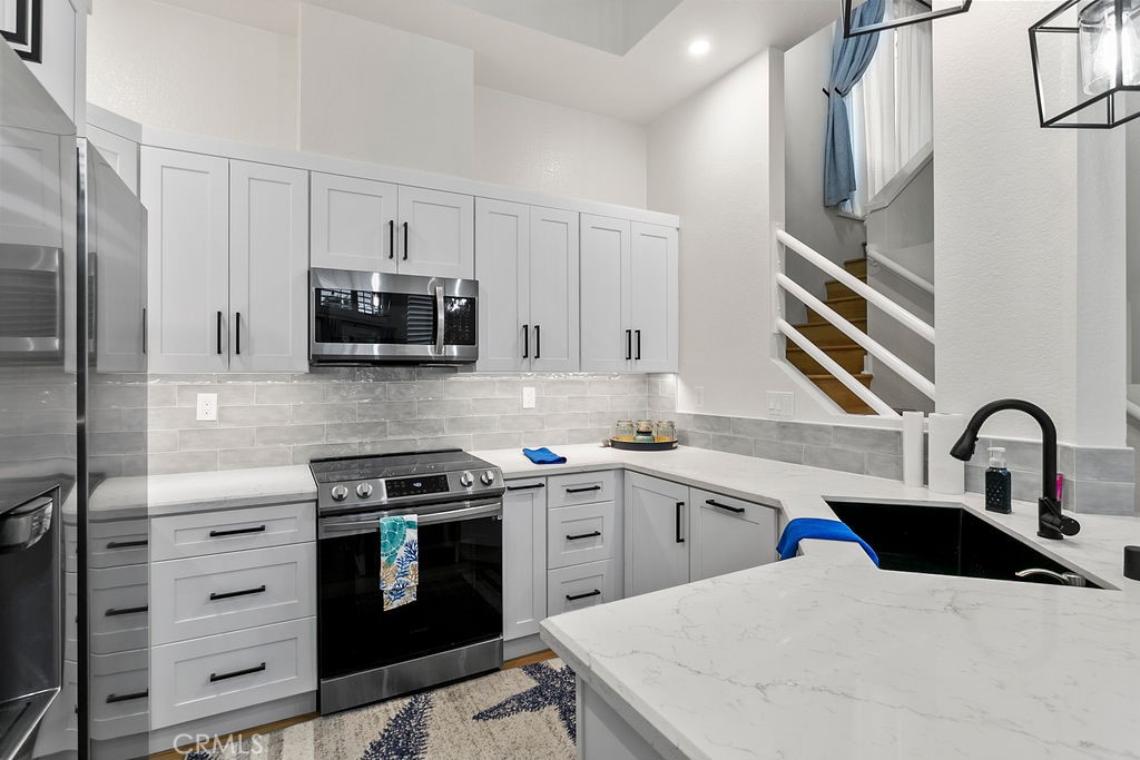 8 Coral Ridge, Unit 109 Laguna Niguel, CA 92677 - Photo 8 of 29 a kitchen with appliances a sink and cabinets