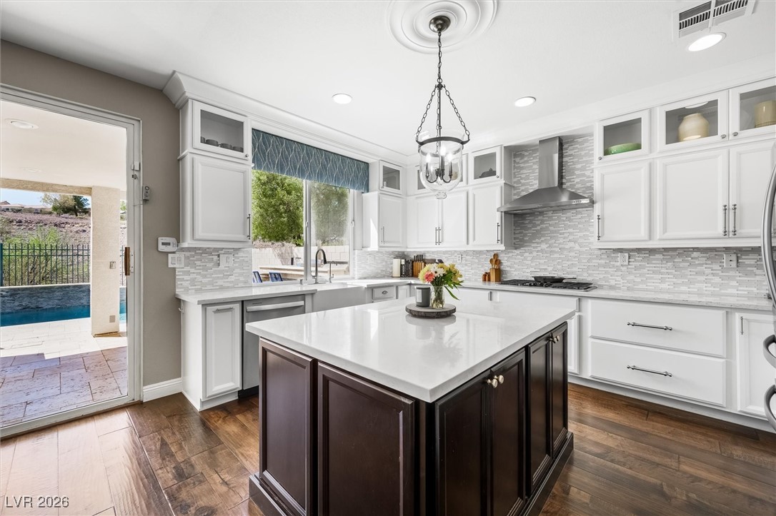1673 Ravanusa Drive Henderson, NV 89052 - Photo 14 of 66 Kitchen featuring glass insert cabinets, tasteful backsplash, white cabinetry, plenty of natural light, and recessed lighting
