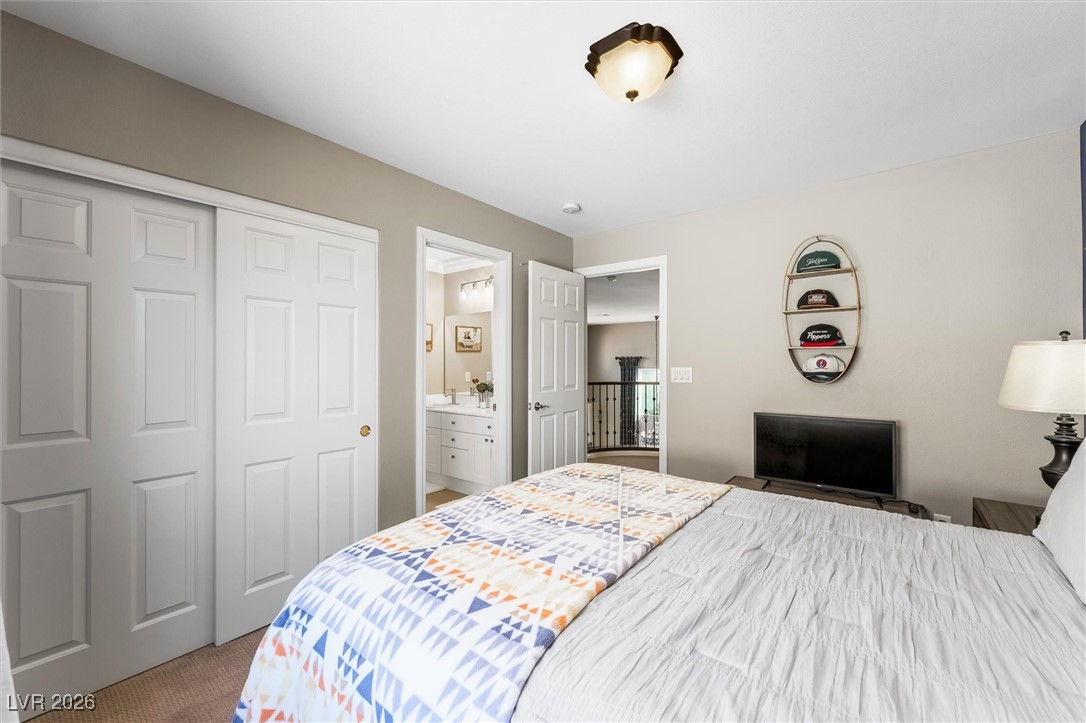 1673 Ravanusa Drive Henderson, NV 89052 - Photo 35 of 66 Bedroom featuring carpet flooring, ensuite bathroom, and a closet