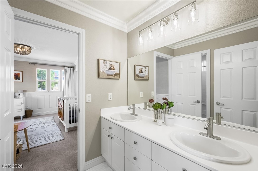 1673 Ravanusa Drive Henderson, NV 89052 - Photo 38 of 66 Full bath with double vanity and crown molding