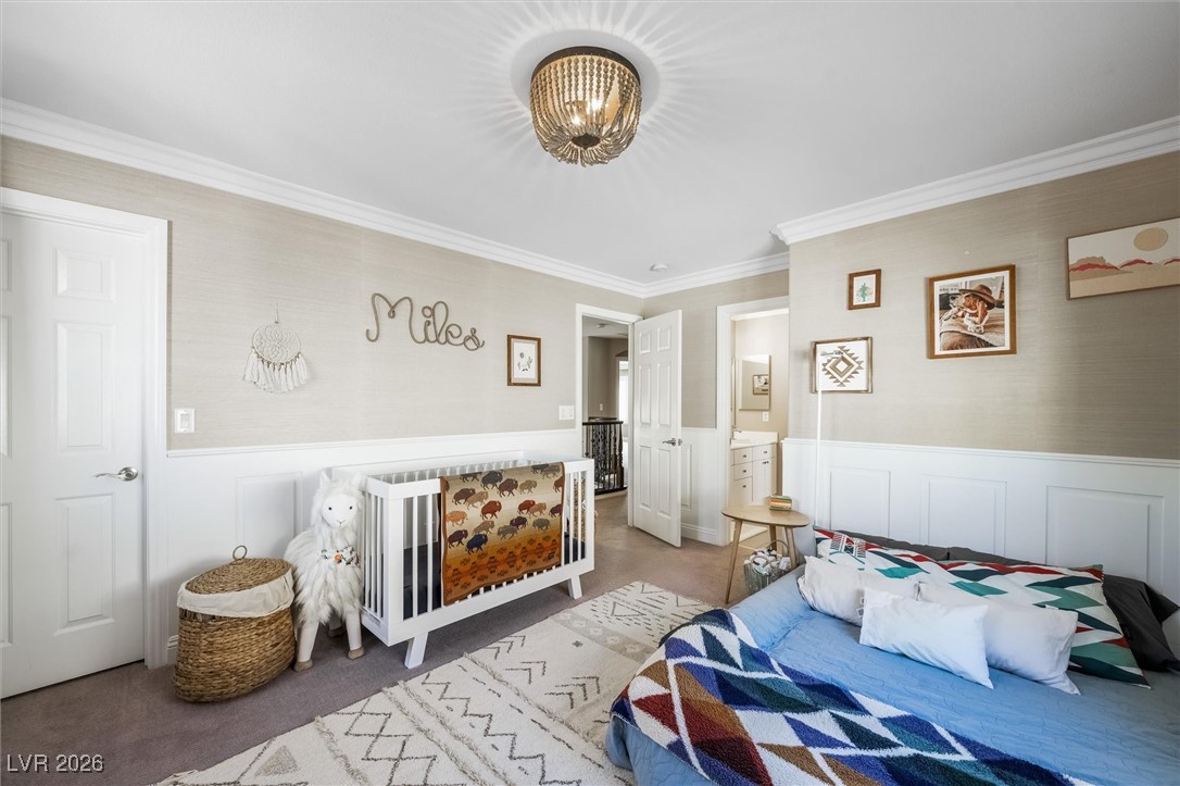 1673 Ravanusa Drive Henderson, NV 89052 - Photo 40 of 66 Bedroom with ornamental molding, a wainscoted wall, a decorative wall, and ensuite bath