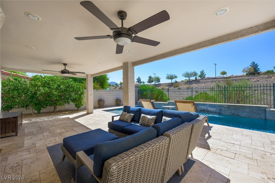1673 Ravanusa Drive Henderson, NV 89052 - Photo 41 of 66 Fenced backyard featuring a patio, outdoor lounge area, and ceiling fan