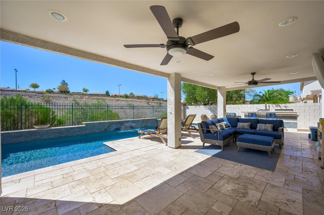 1673 Ravanusa Drive Henderson, NV 89052 - Photo 42 of 66 View of swimming pool with outdoor lounge area, a patio, a fenced backyard, and ceiling fan
