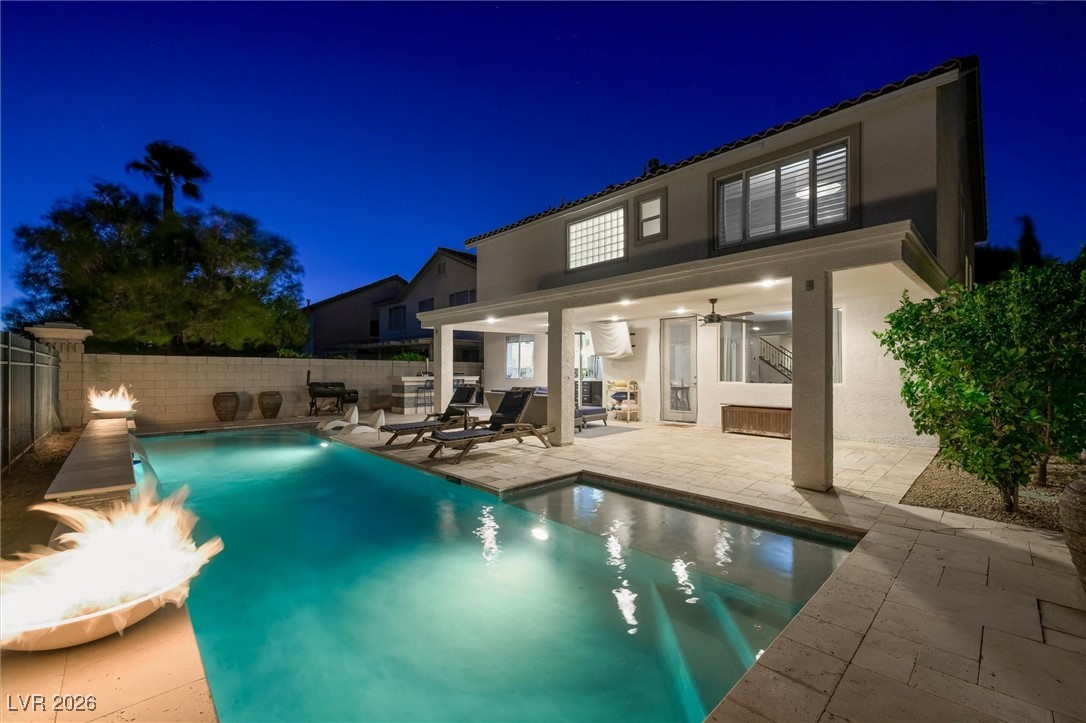 1673 Ravanusa Drive Henderson, NV 89052 - Photo 49 of 66 Back of house at twilight featuring a patio, stucco siding, ceiling fan, and a fenced backyard