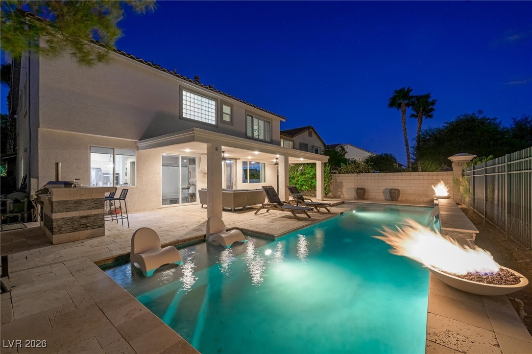 1673 Ravanusa Drive Henderson, NV 89052 - Photo 50 of 66 Pool at night with a patio and a fenced backyard