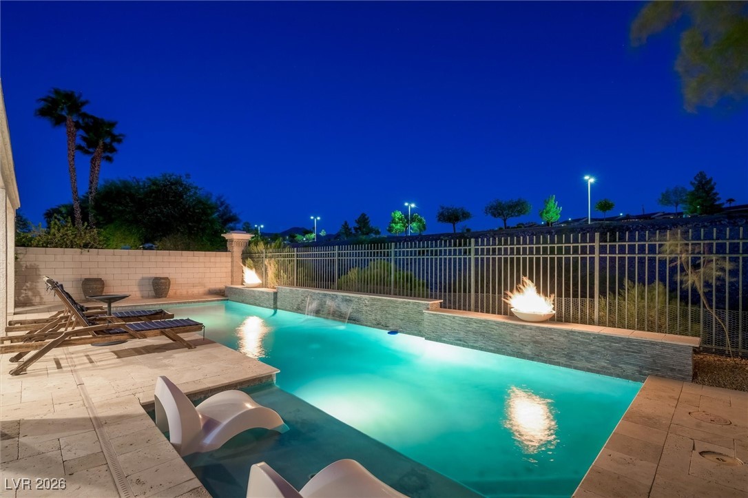 1673 Ravanusa Drive Henderson, NV 89052 - Photo 52 of 66 Pool at twilight featuring a patio area and a fenced backyard