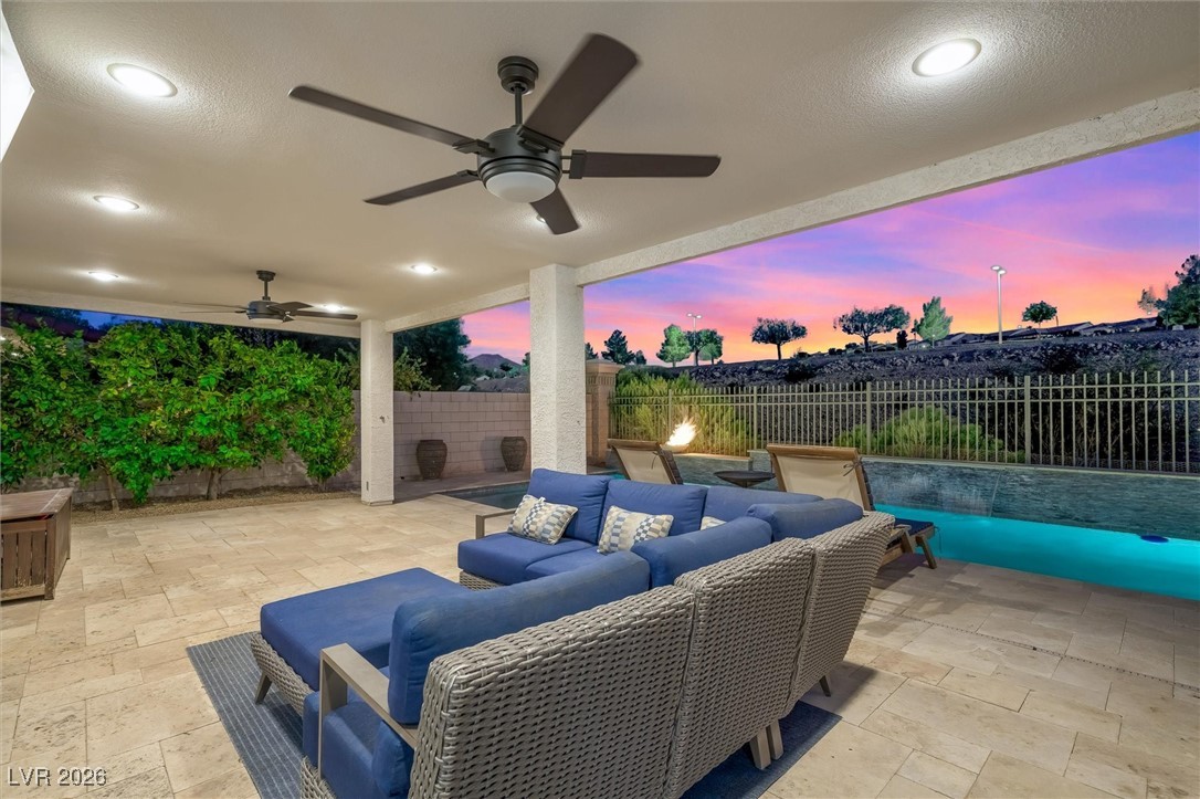 1673 Ravanusa Drive Henderson, NV 89052 - Photo 53 of 66 Patio terrace at dusk with a fenced backyard, a patio, outdoor lounge area, and a ceiling fan