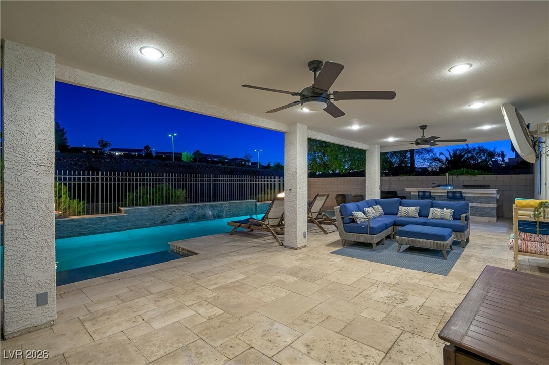 1673 Ravanusa Drive Henderson, NV 89052 - Photo 54 of 66 Patio at night featuring an outdoor living space, a fenced backyard, a patio, and ceiling fan