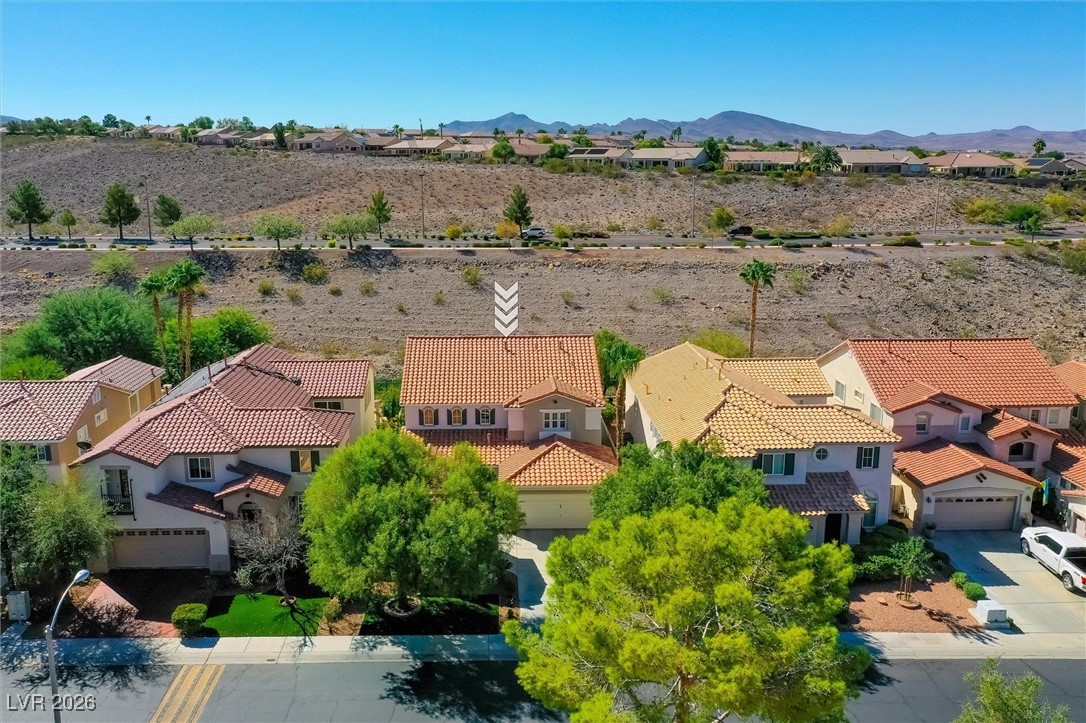 1673 Ravanusa Drive Henderson, NV 89052 - Photo 56 of 66 Aerial perspective of suburban area with a mountain backdrop