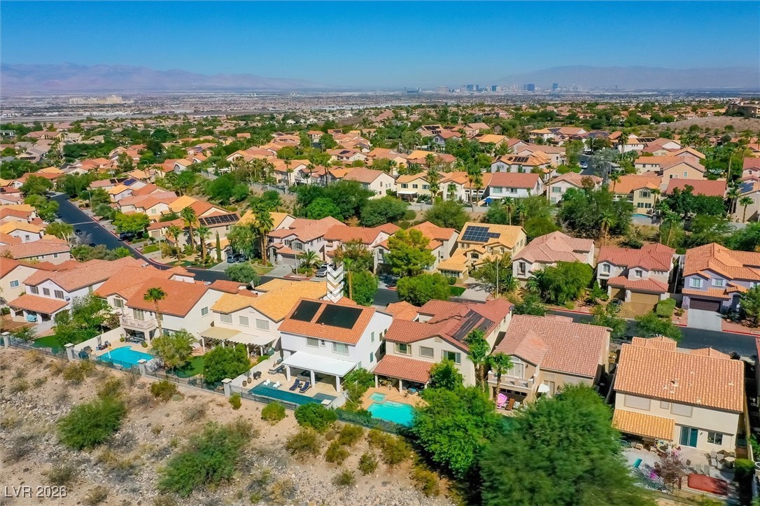 1673 Ravanusa Drive Henderson, NV 89052 - Photo 63 of 66 Aerial view of property and surrounding area with mountains and nearby suburban area