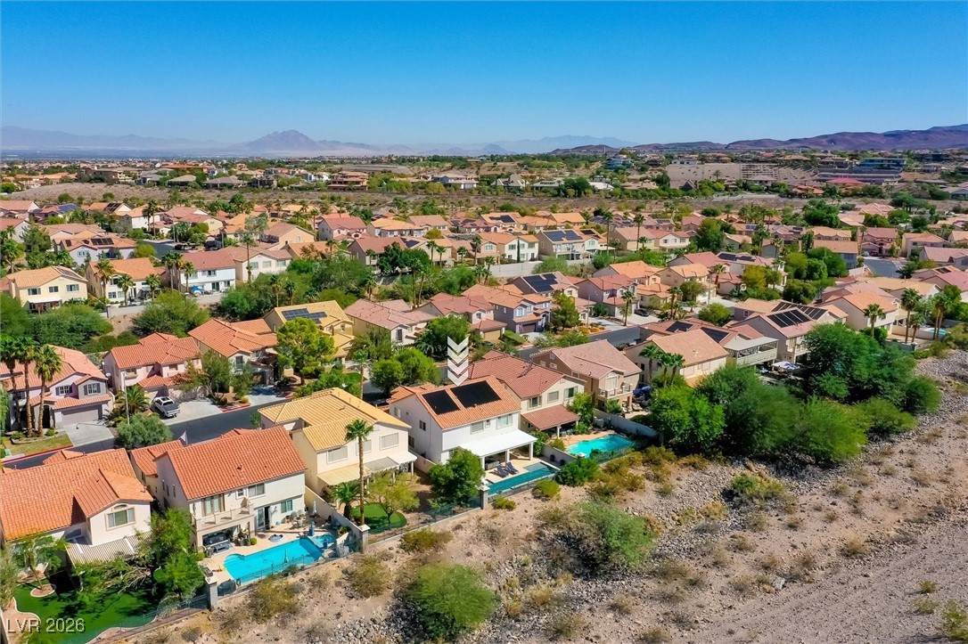 1673 Ravanusa Drive Henderson, NV 89052 - Photo 65 of 66 Aerial view of residential area featuring a mountain backdrop and a pool area