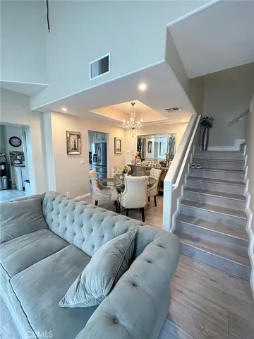 a living room with furniture and stairs