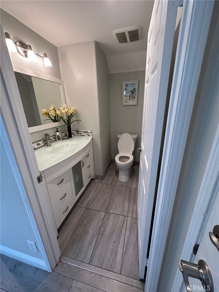 19017 Gault Street, Unit 106 Reseda, CA 91335 - Photo 6 of 6 a bathroom with a sink and mirror with toilet