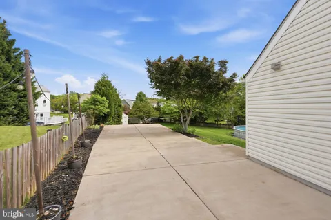 a view of a pathway with a wrought fence