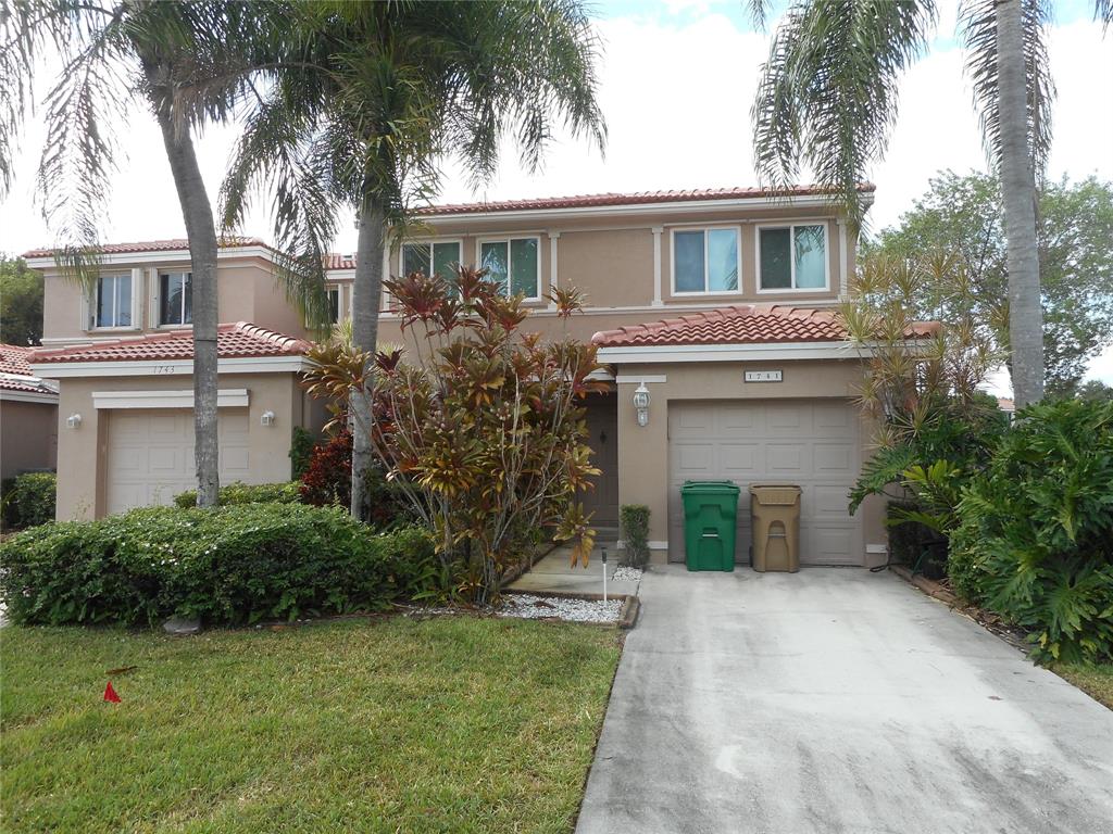 1741 Southwest 109th Terrace Davie, FL 33324 - Photo 2 of 10 a view of a house with a yard and palm trees