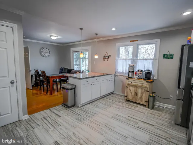 a kitchen with a sink cabinets and wooden floor