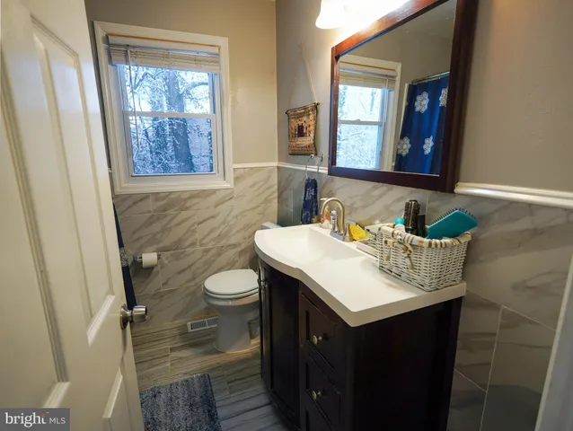 a bathroom with a sink vanity and a mirror