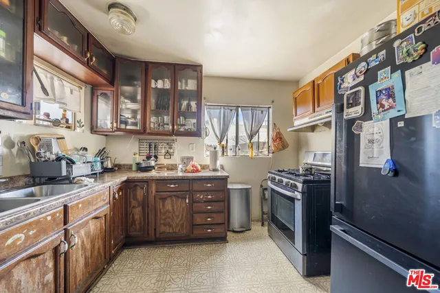 a kitchen with stainless steel appliances granite countertop a stove a sink dishwasher and a refrigerator
