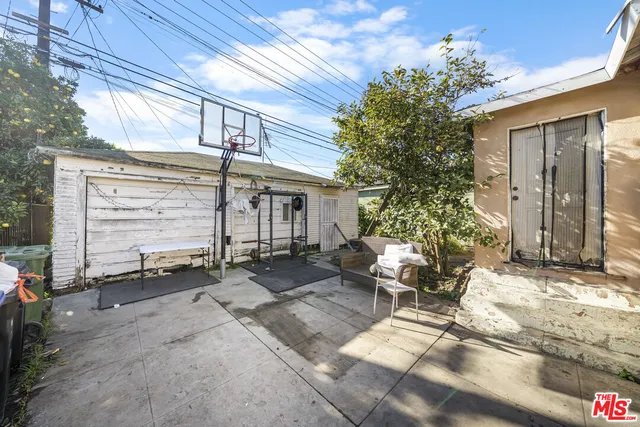 a backyard of a house with outdoor seating