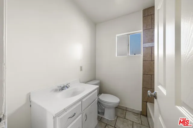 a bathroom with a sink toilet and vanity