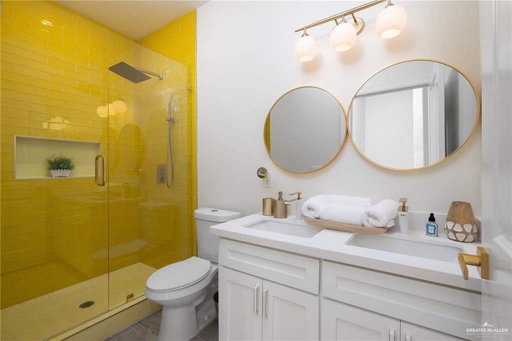 1009 Bass Avenue, Unit 1 Port Isabel, TX 78578 - Photo 13 of 19 a bathroom with a toilet sink and mirror