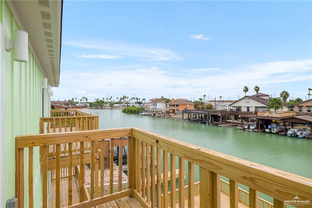 1009 Bass Avenue, Unit 1 Port Isabel, TX 78578 - Photo 16 of 19 a view of a lake with boats and trees in the background