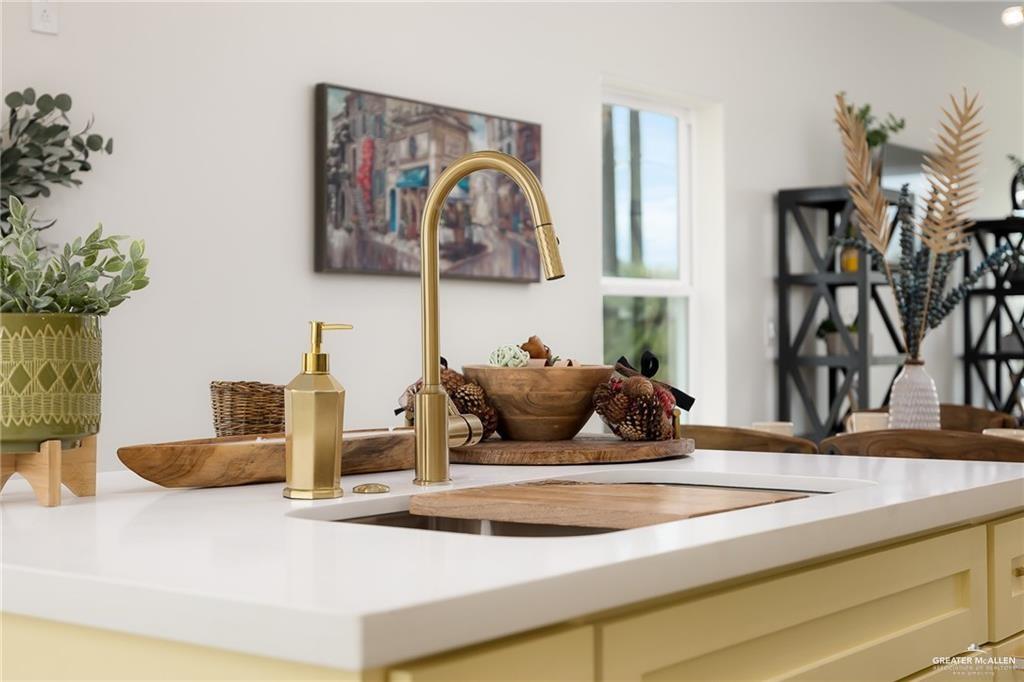 1009 Bass Avenue, Unit 1 Port Isabel, TX 78578 - Photo 10 of 19 a bedroom with a large bed and a chandelier