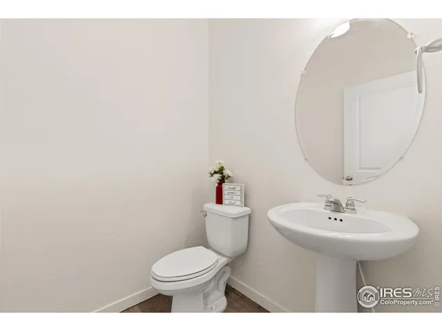 a bathroom with a sink toilet and a mirror