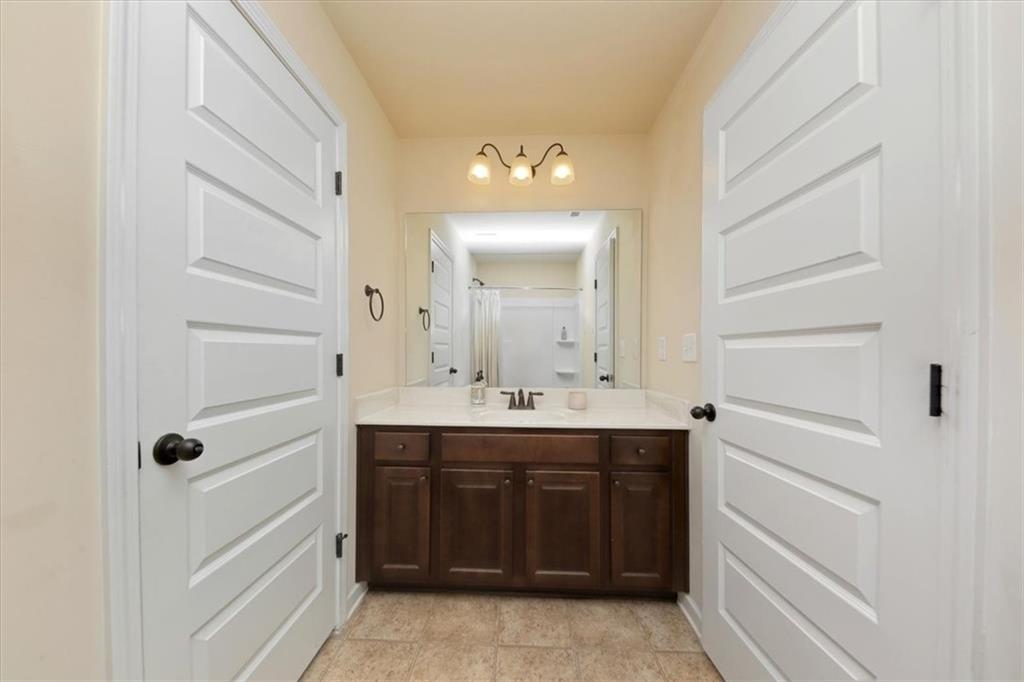 4058 Rosebay Way Southwest Conyers, GA 30094 - Photo 24 of 55 a bathroom with a sink vanity and mirror
