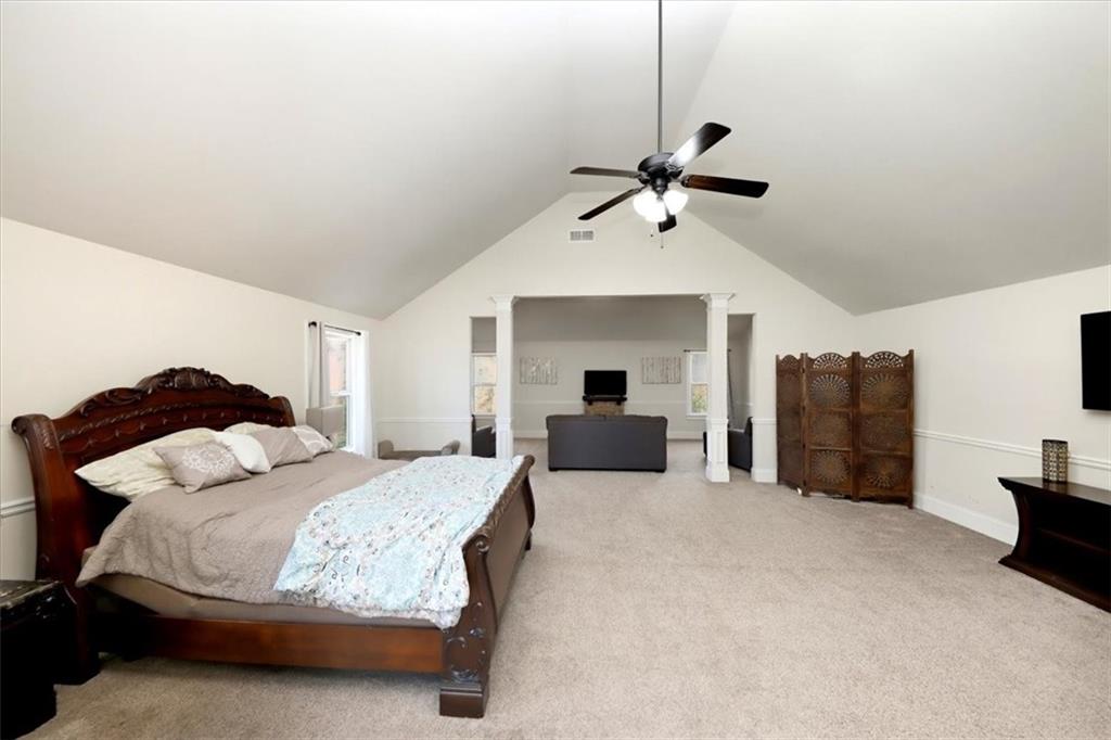 4058 Rosebay Way Southwest Conyers, GA 30094 - Photo 28 of 55 a spacious bedroom with a bed and ceiling fan