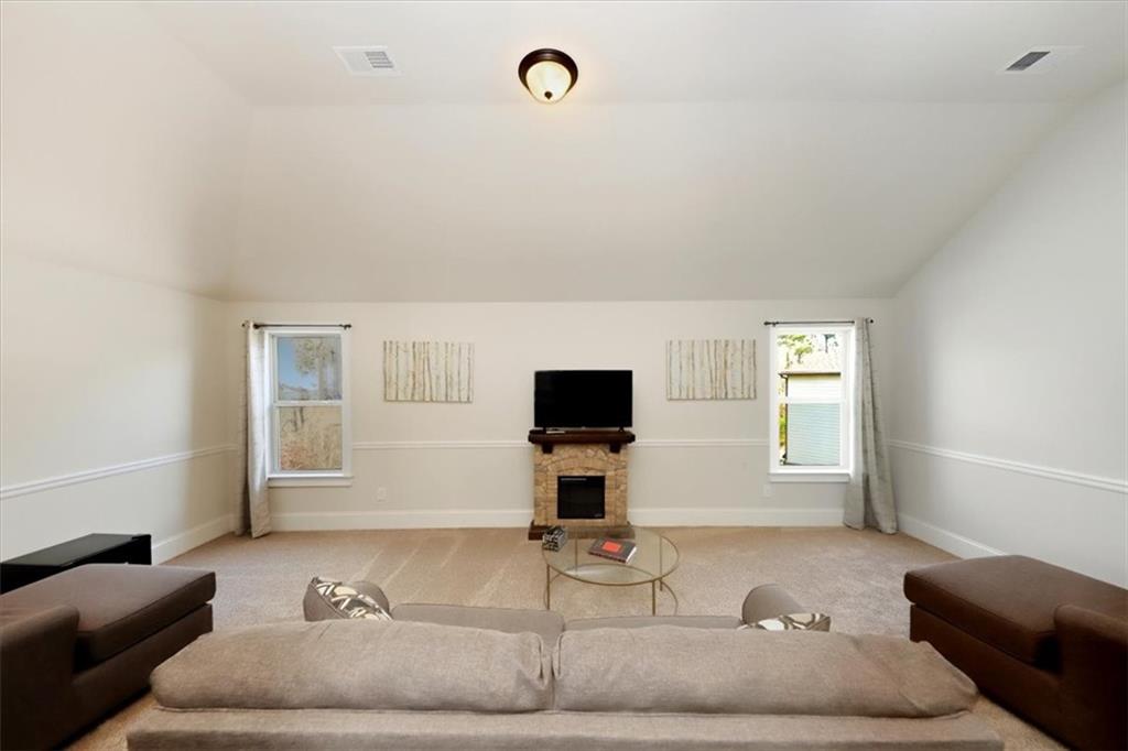 4058 Rosebay Way Southwest Conyers, GA 30094 - Photo 29 of 55 a living room with furniture and a flat screen tv