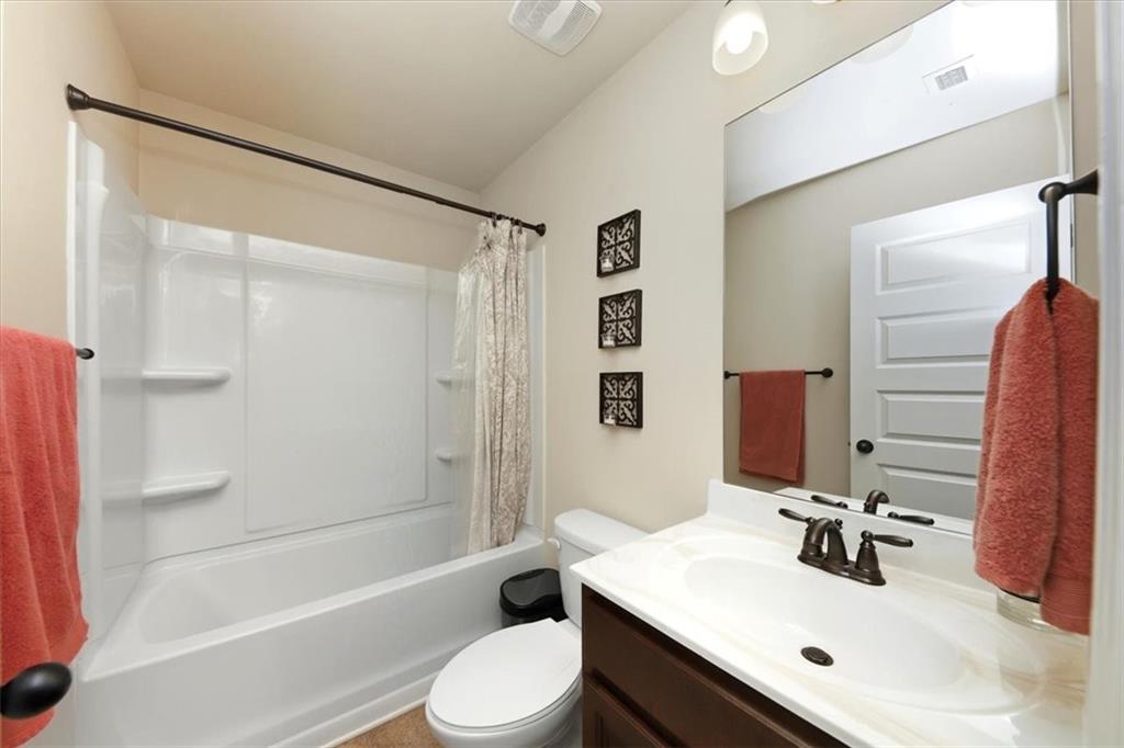 4058 Rosebay Way Southwest Conyers, GA 30094 - Photo 34 of 55 a bathroom with a sink a toilet and shower