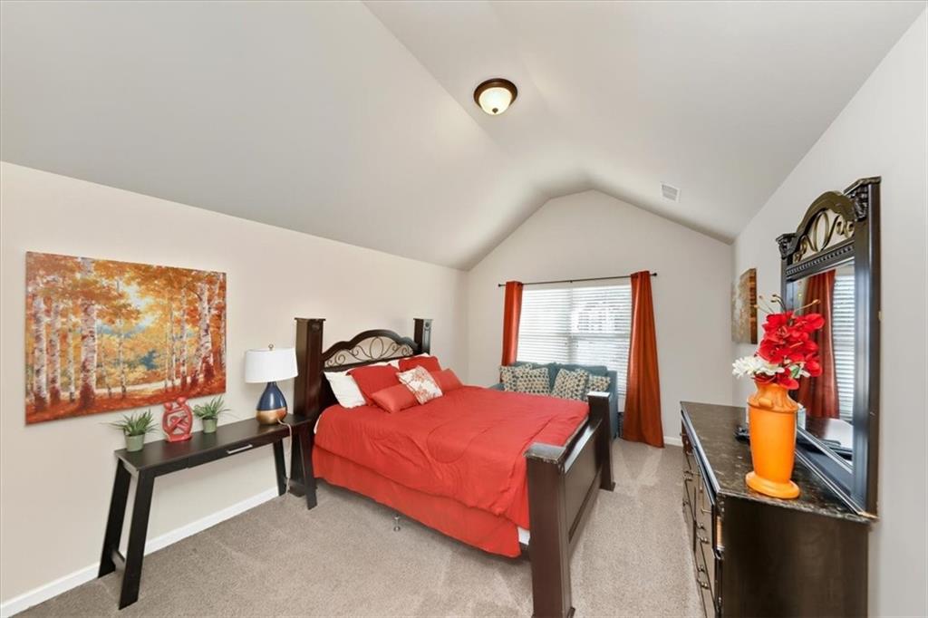 4058 Rosebay Way Southwest Conyers, GA 30094 - Photo 35 of 55 a bedroom with a bed and wooden floor